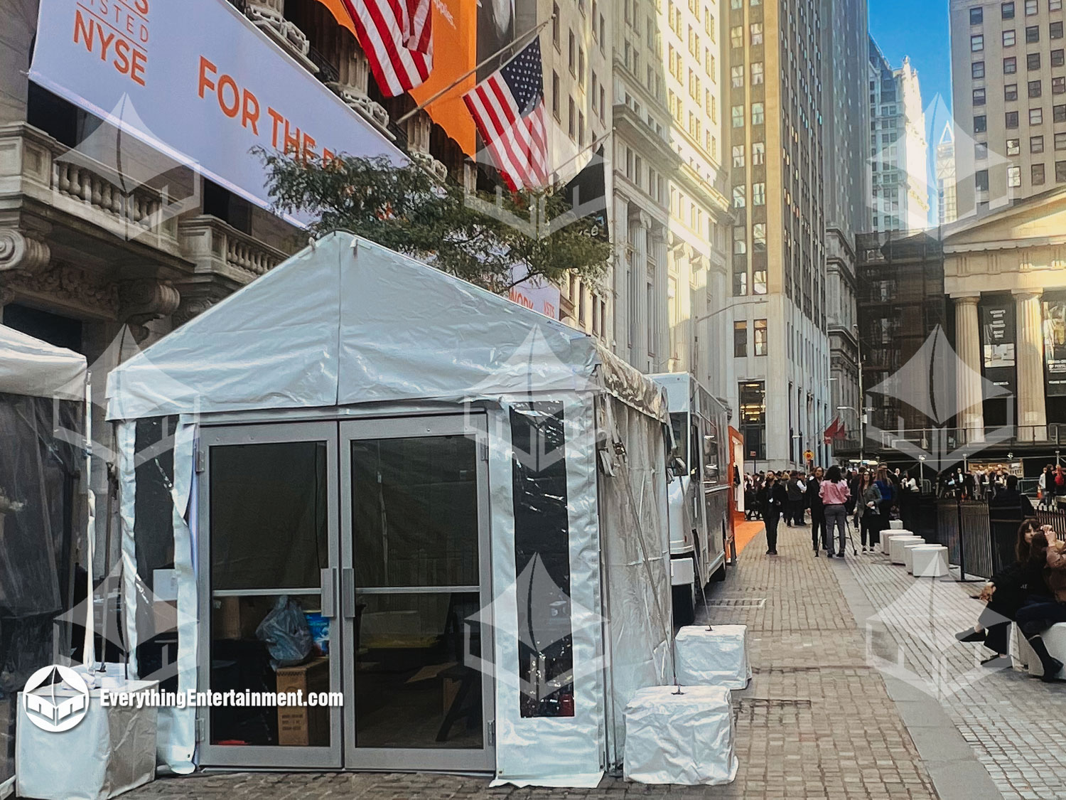 A professional 10x10 white frame tent setup for an event at the NY Stock Exchange