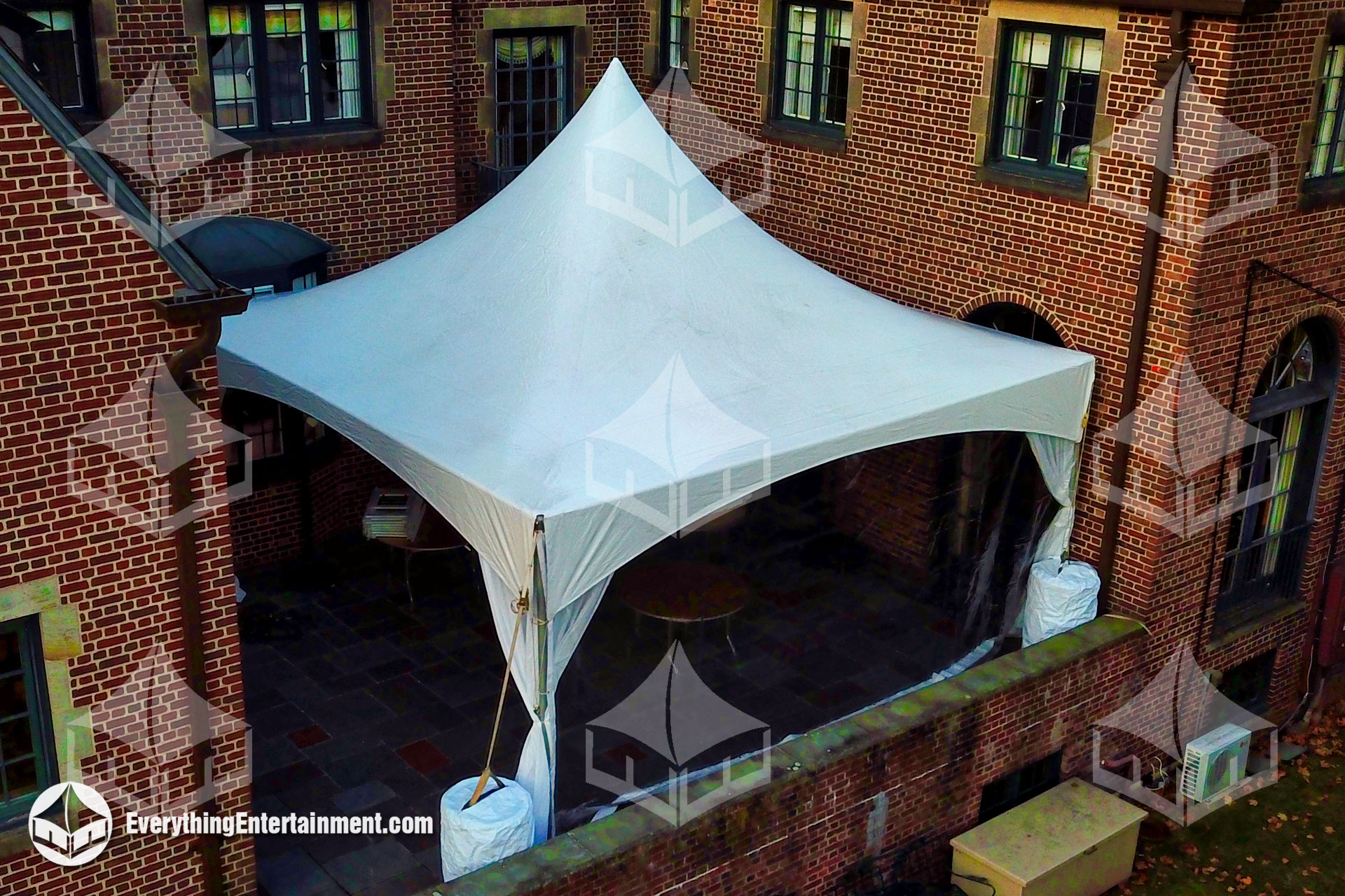20x20 high peak marquee tent setup on a residential deck for an outdoor event