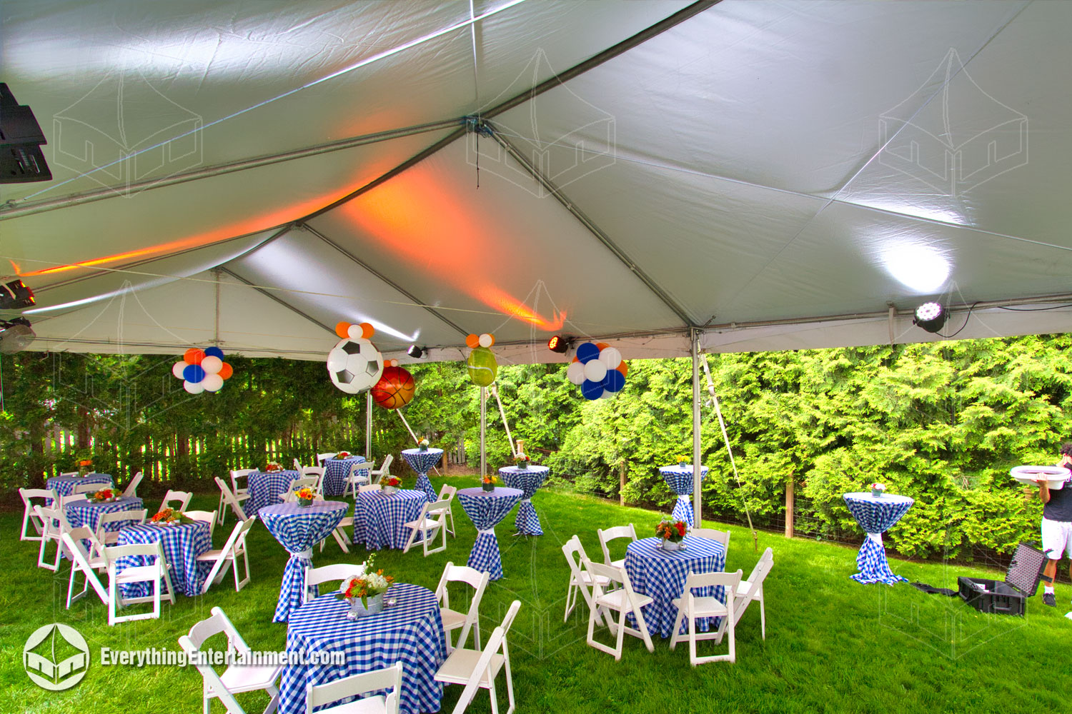 Interior of a 20x50 frame tent on grass, with garden chairs and tables
