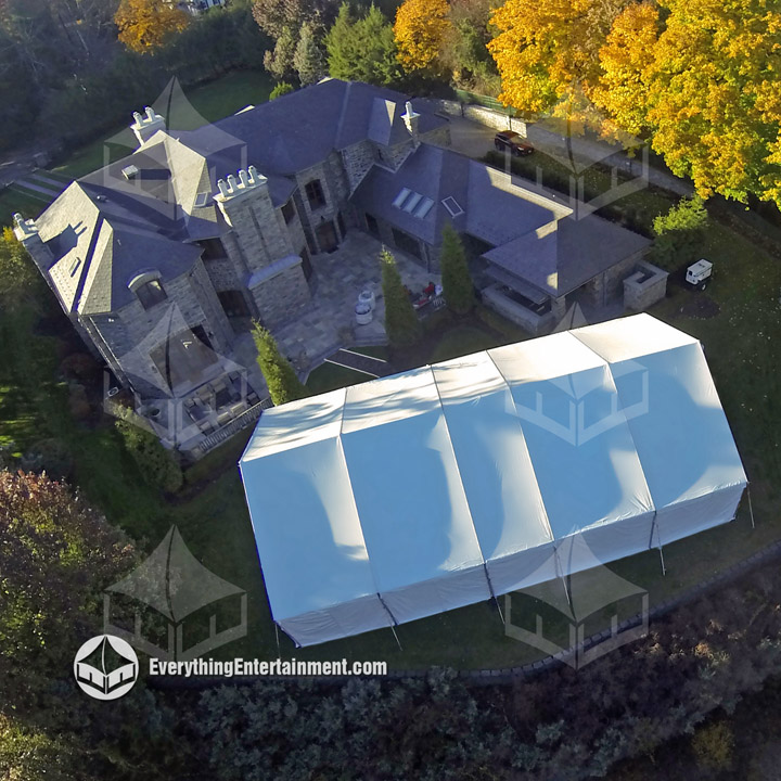 Aerial view of large tent in backyard.