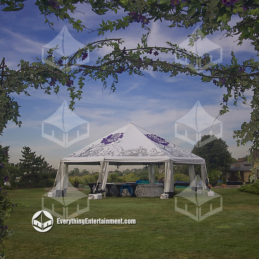An octagon tent setup on grass with blue sky